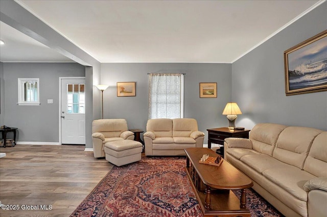 living room featuring ornamental molding, wood finished floors, and baseboards