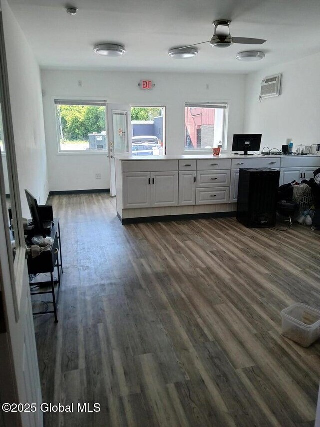 1317 Lower Broadway, Schenectady, NY 12306 - home office featuring dark wood-type flooring, an AC wall unit, and a ceiling fan