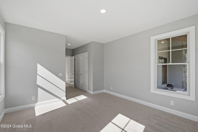 unfurnished room featuring carpet floors, baseboards, and recessed lighting