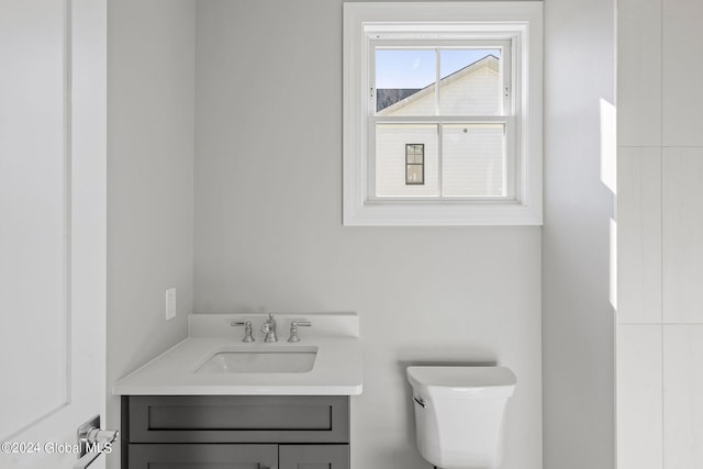 bathroom featuring toilet and vanity