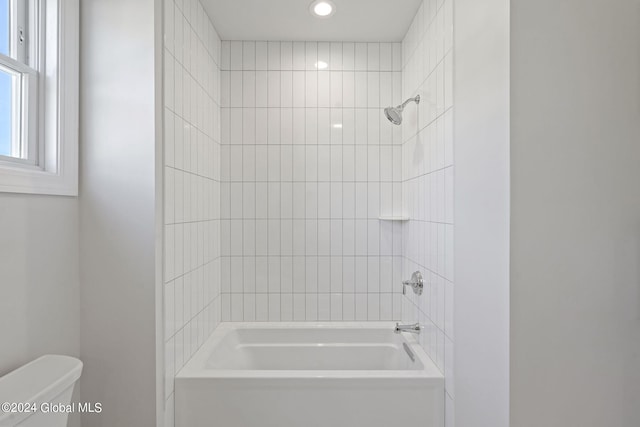 bathroom with toilet, washtub / shower combination, and recessed lighting