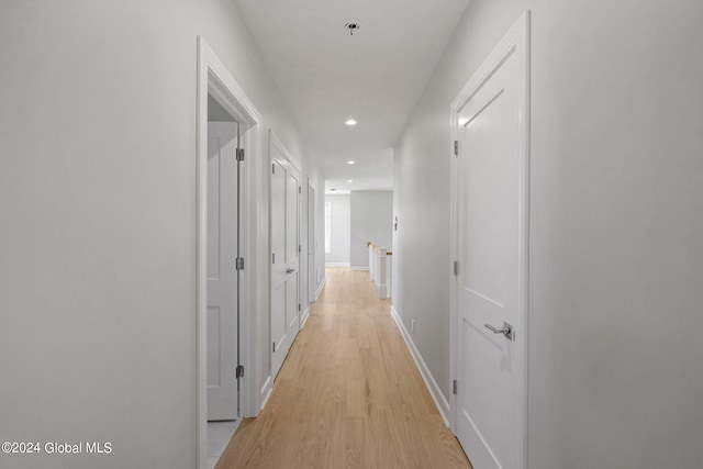 hall featuring recessed lighting, light wood-style flooring, and baseboards