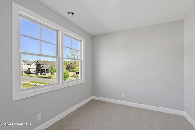 empty room with baseboards and carpet floors