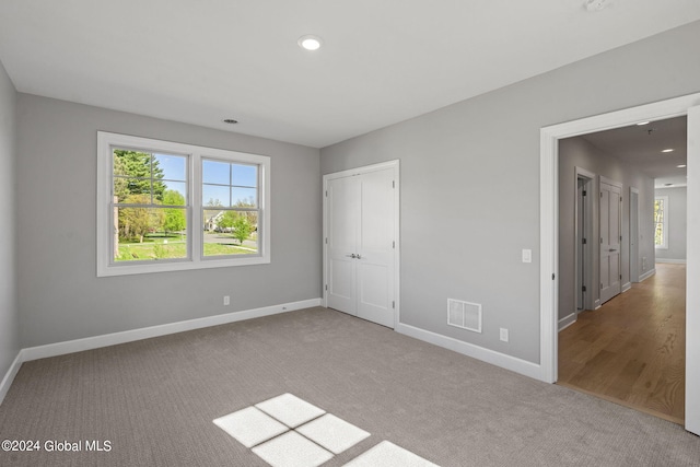 unfurnished bedroom featuring baseboards, carpet floors, and recessed lighting