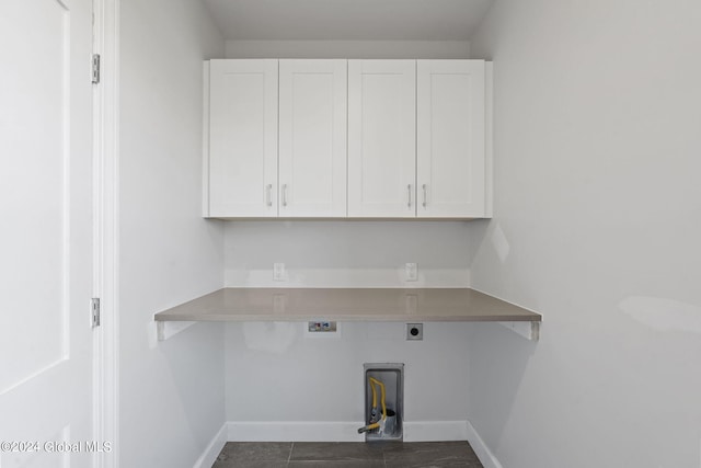 laundry room with cabinet space, electric dryer hookup, baseboards, and washer hookup