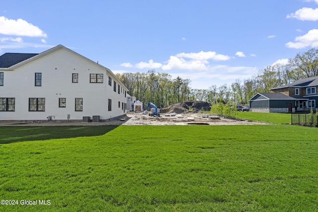 view of green lawn featuring central AC