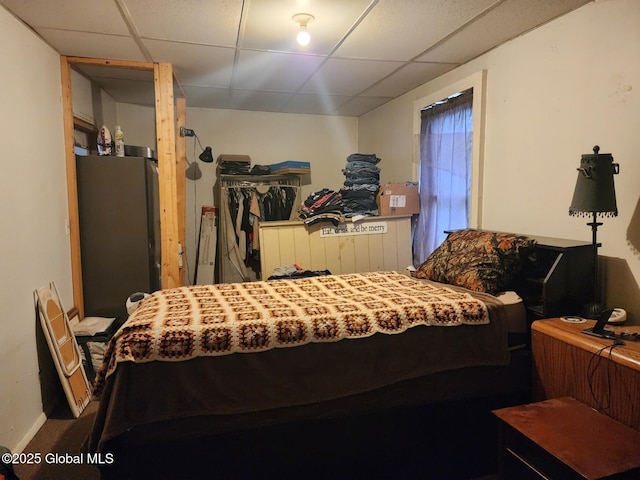 bedroom featuring carpet floors and a paneled ceiling