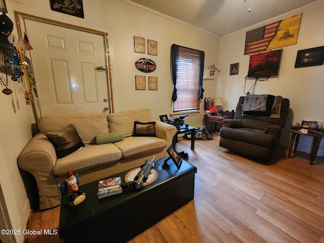 living room with ornamental molding and wood finished floors