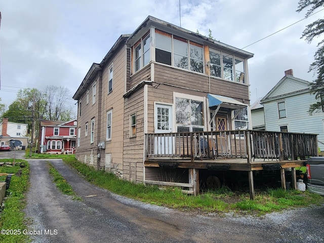 back of house featuring a deck