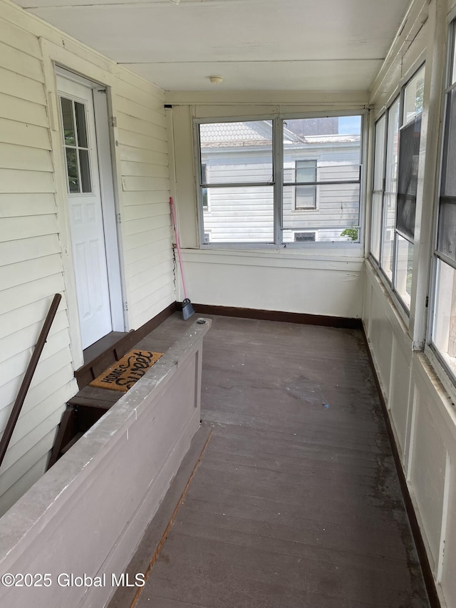 unfurnished sunroom featuring a wealth of natural light