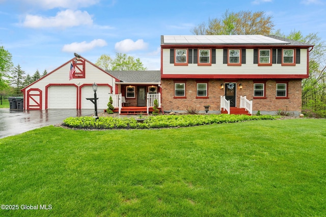 228 Maura Ln, Glenville, NY 12302 - colonial house with driveway, a front yard, a garage, brick siding, and a porch