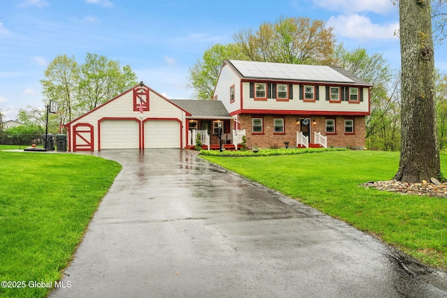 228 Maura Ln, Glenville, NY 12302 - colonial house with a garage, brick siding, asphalt driveway, a front yard, and covered porch