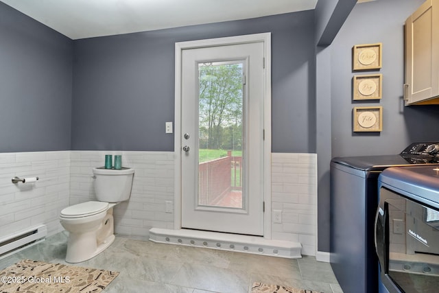 228 Maura Ln, Glenville, NY 12302 - laundry room with washer and clothes dryer, a baseboard heating unit, tile walls, a wainscoted wall, and tile patterned floors