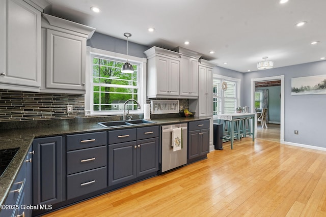 228 Maura Ln, Glenville, NY 12302 - kitchen featuring dishwasher, a sink, dark countertops, backsplash, and recessed lighting