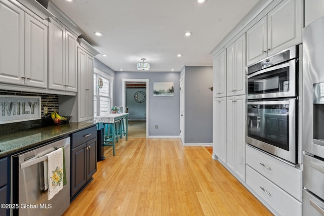 228 Maura Ln, Glenville, NY 12302 - kitchen with appliances with stainless steel finishes, tasteful backsplash, recessed lighting, light wood-style flooring, and baseboards