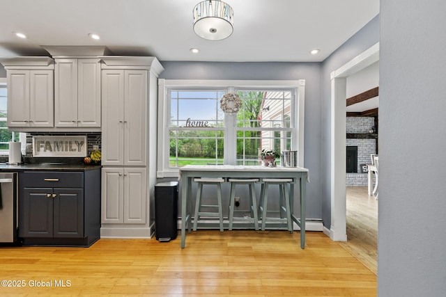 228 Maura Ln, Glenville, NY 12302 - bar area with light wood-type flooring, recessed lighting, a brick fireplace, and a baseboard radiator