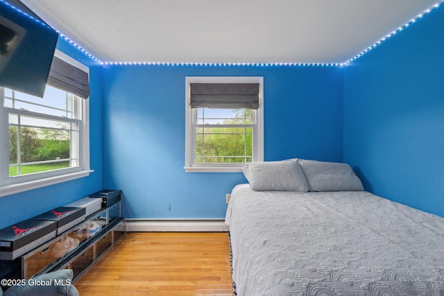 228 Maura Ln, Glenville, NY 12302 - bedroom with a baseboard heating unit, wood finished floors, and baseboards