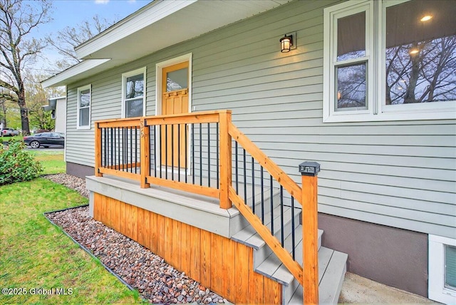 entrance to property with a lawn