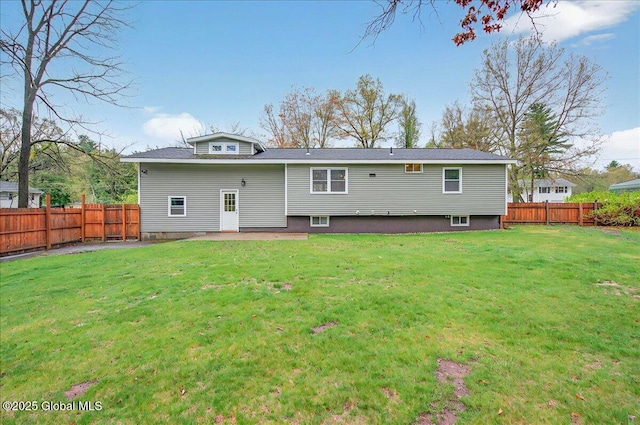 back of property featuring a fenced backyard, a patio, and a lawn