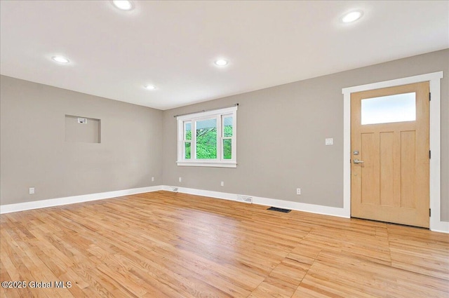 interior space with visible vents, light wood-style flooring, baseboards, and recessed lighting
