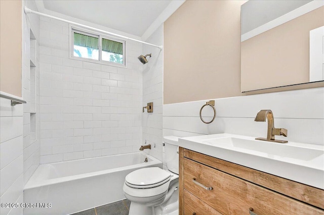 full bathroom featuring toilet, shower / bath combination, vanity, and wainscoting