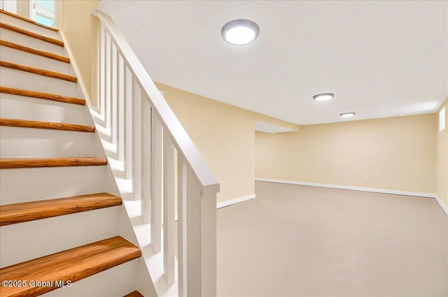 stairway with baseboards, carpet floors, and recessed lighting