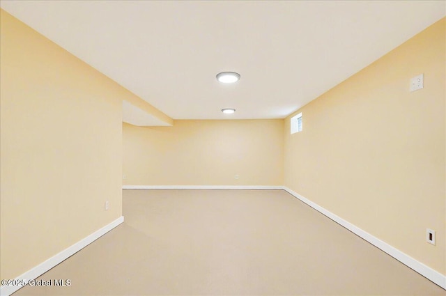 basement with baseboards, carpet flooring, and visible vents