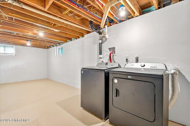 laundry area with washer and clothes dryer, laundry area, and a wealth of natural light
