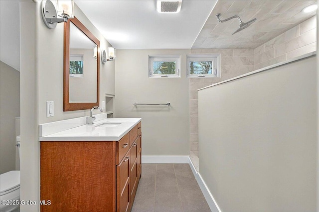 bathroom featuring toilet, visible vents, tile patterned floors, a walk in shower, and baseboards