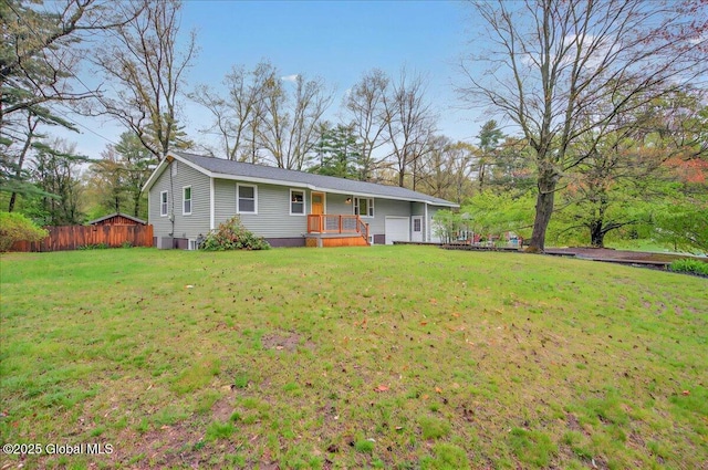 ranch-style home featuring cooling unit, a front lawn, and fence