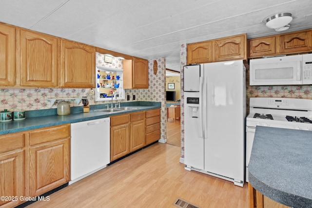 28 Buyce Cross, Thurman, NY 12810 - kitchen with white appliances, a sink, light wood-style floors, and dark countertops