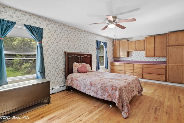 28 Buyce Cross, Thurman, NY 12810 - bedroom with light wood-style floors, a baseboard radiator, and wallpapered walls