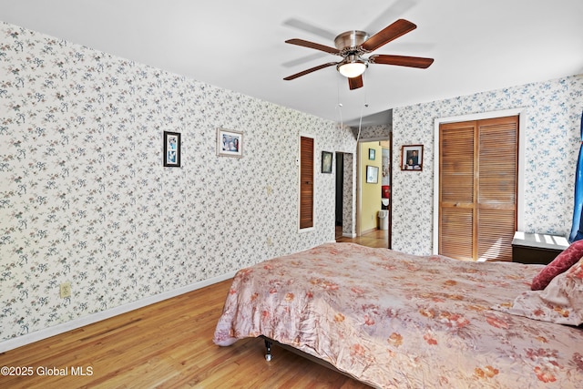 28 Buyce Cross, Thurman, NY 12810 - bedroom featuring wallpapered walls, wood finished floors, baseboards, ceiling fan, and a closet