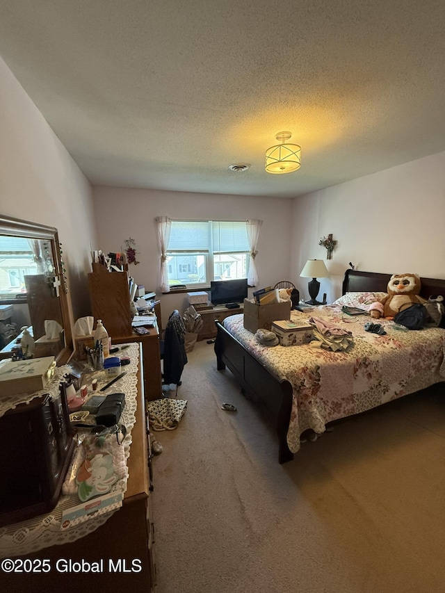bedroom with carpet floors and a textured ceiling