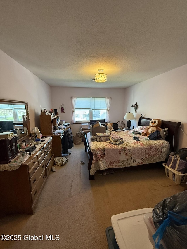 carpeted bedroom featuring a textured ceiling