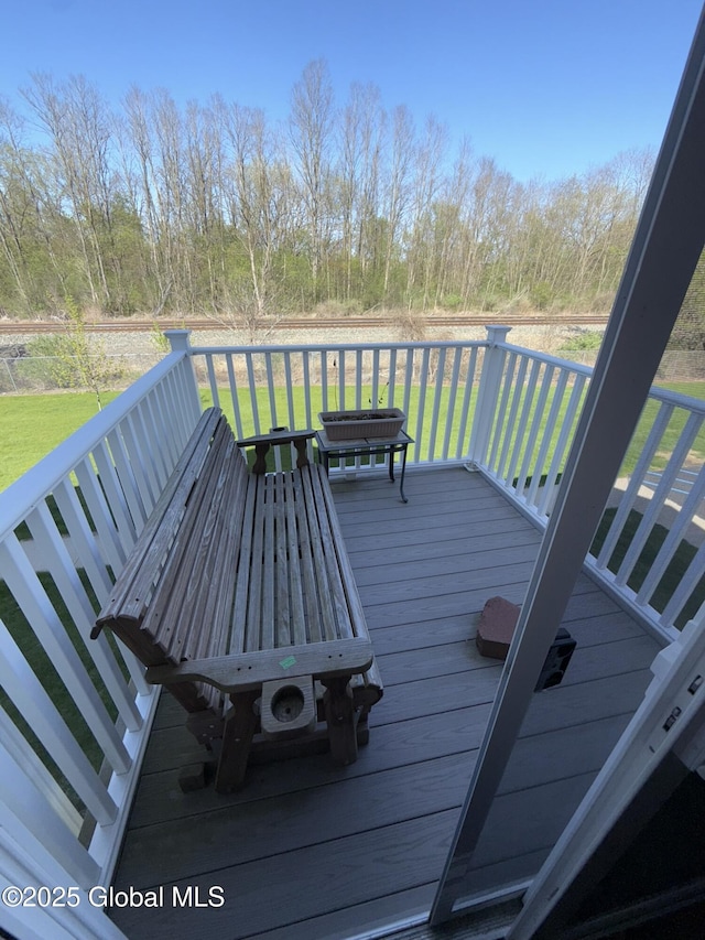 wooden terrace with a yard