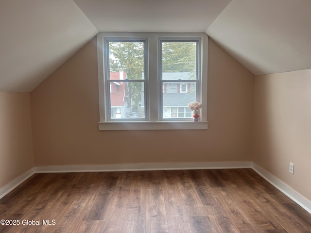 bonus room featuring lofted ceiling, wood finished floors, and baseboards