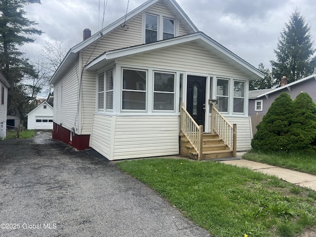 1732 Ave H, Schenectady, NY 12304 - view of front of property with entry steps, a chimney, asphalt driveway, and a detached garage