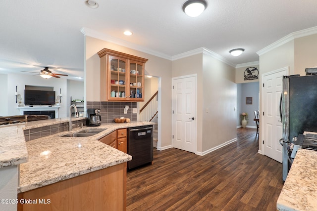kitchen with dishwashing machine, a sink, dark wood finished floors, a ceiling fan, and glass insert cabinets