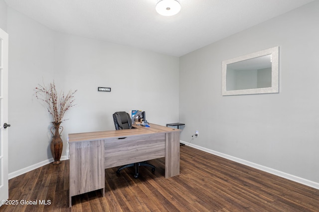 office space with baseboards and dark wood-style floors