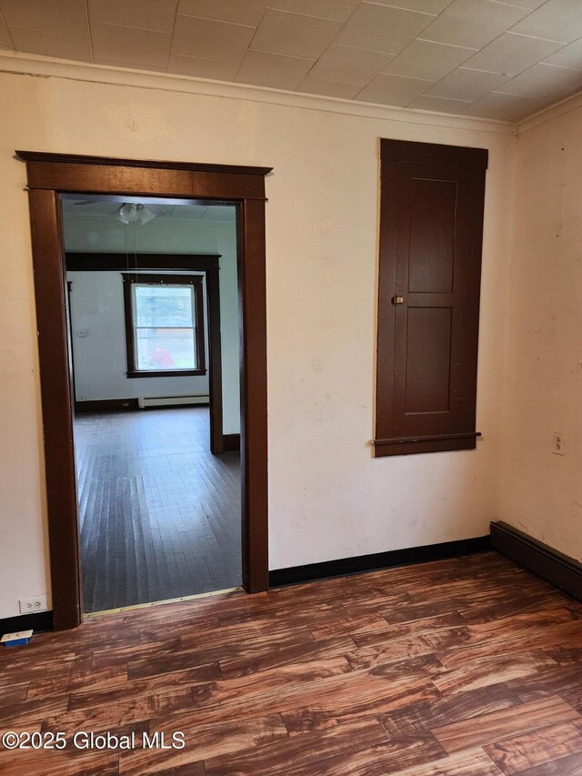 31 Fort Johnson Ave, Fort Johnson, NY 12070 - empty room with crown molding, baseboards, wood finished floors, and a baseboard radiator