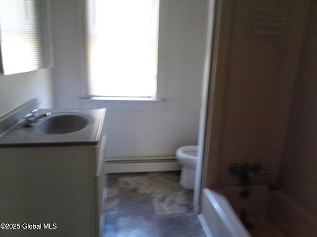 31 Fort Johnson Ave, Fort Johnson, NY 12070 - bathroom with toilet, vanity, a baseboard heating unit, and washtub / shower combination