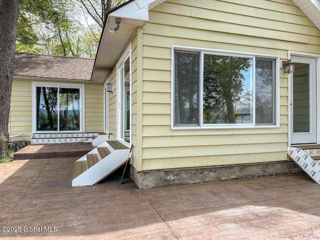 233 Cleverdale Rd, Queensbury, NY 12804 - view of home's exterior with entry steps, a patio area, and roof with shingles