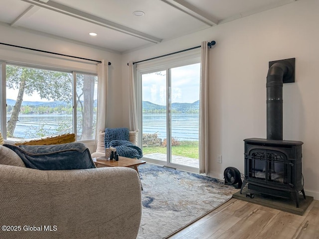 233 Cleverdale Rd, Queensbury, NY 12804 - living area featuring a wood stove, light wood-type flooring, beam ceiling, recessed lighting, and baseboards
