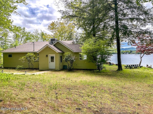 233 Cleverdale Rd, Queensbury, NY 12804 - back of property with a water view, a chimney, roof with shingles, and a yard