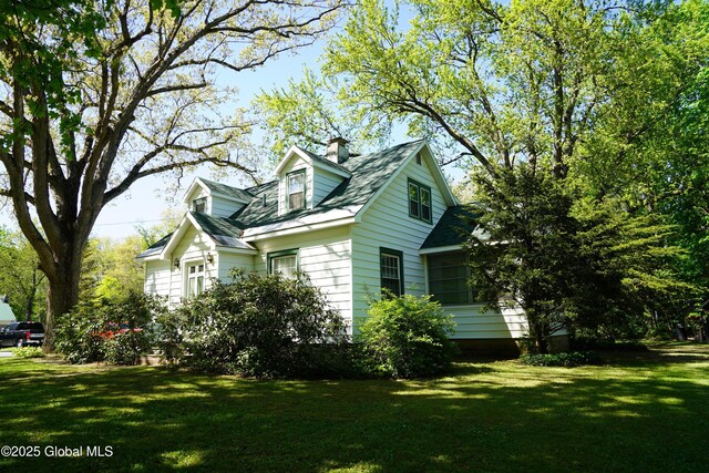 31 Thomas Ave, Hudson Falls, NY 12839 - view of home's exterior with a lawn and a chimney