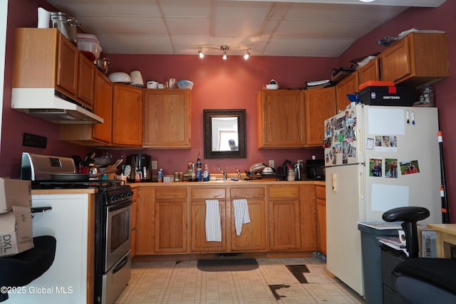 31 Thomas Ave, Hudson Falls, NY 12839 - kitchen featuring under cabinet range hood, stainless steel gas stove, freestanding refrigerator, and light flooring