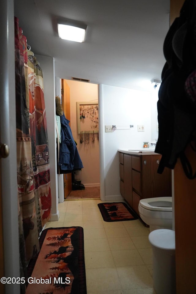 31 Thomas Ave, Hudson Falls, NY 12839 - bathroom featuring toilet, vanity, a bidet, and baseboards