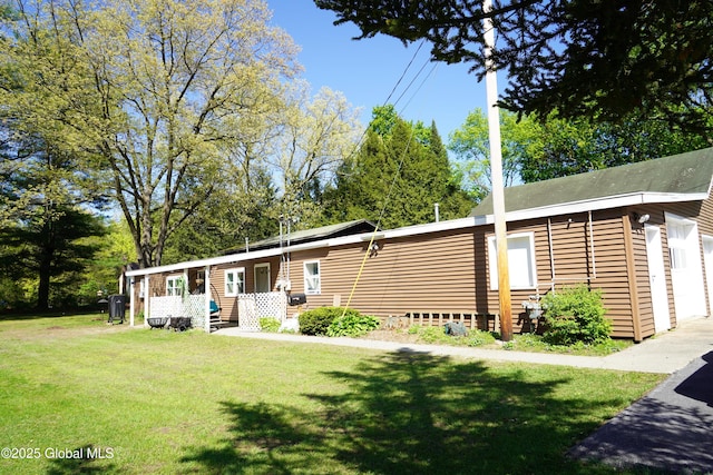 31 Thomas Ave, Hudson Falls, NY 12839 - manufactured / mobile home featuring a front lawn and a garage