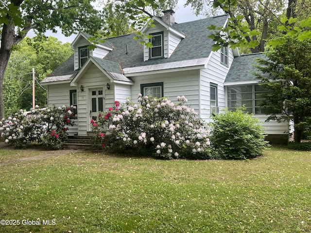31 Thomas Ave, Hudson Falls, NY 12839 - new england style home with a chimney, a front yard, roof with shingles, and a sunroom